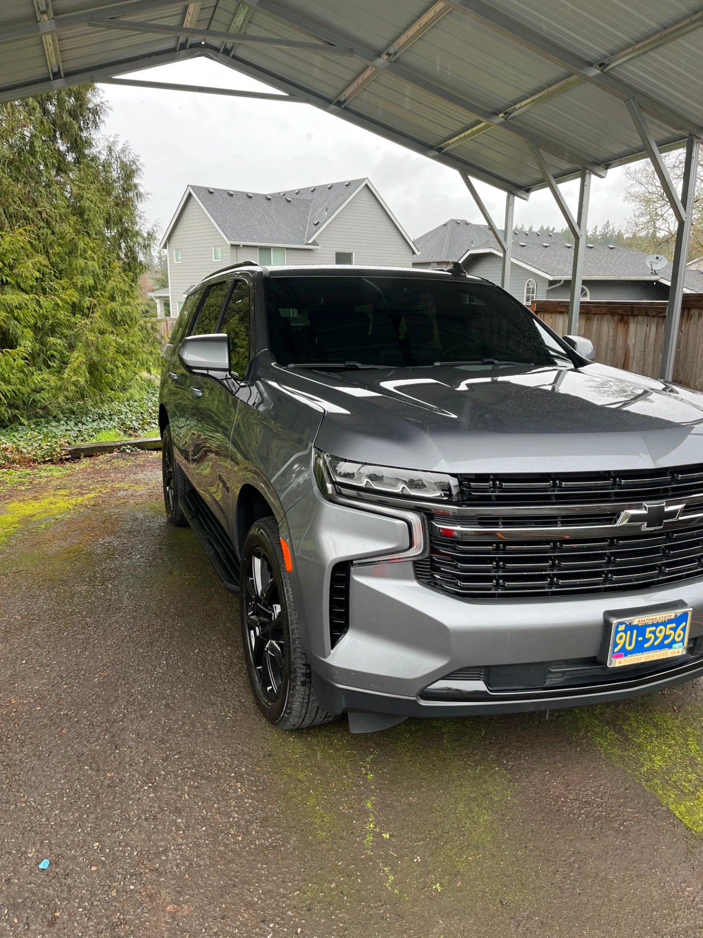 Silver Chevrolet SUV parked under a residential carport